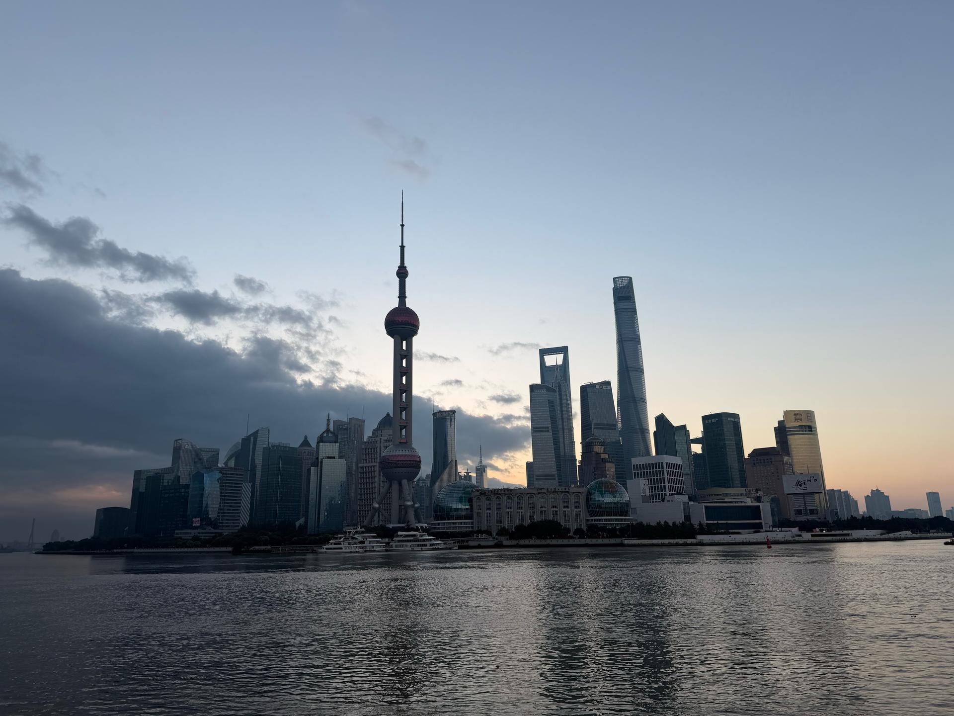 View of the Shanghai skyline, with the river in the foreground.