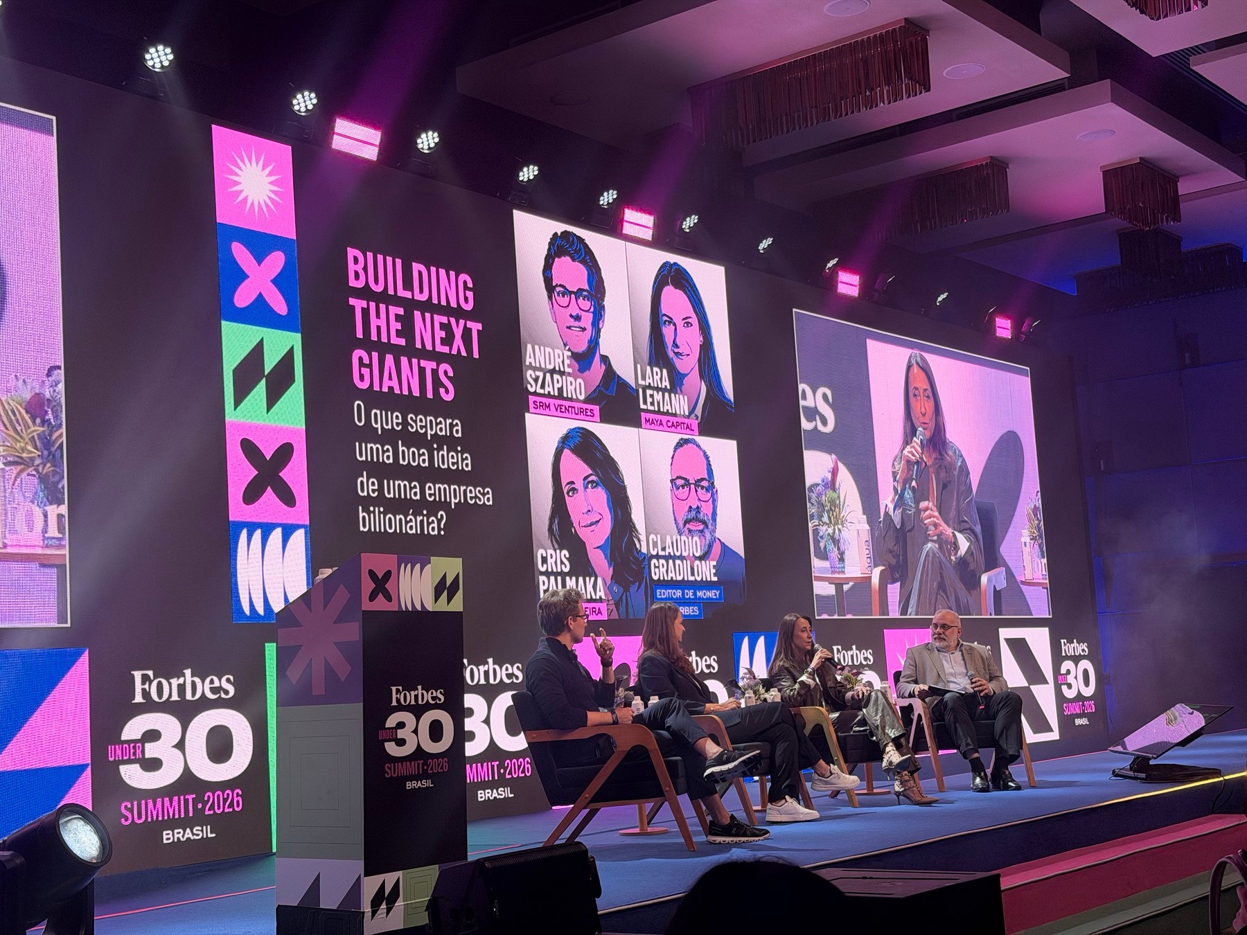 Panelists onstage, with the title Building the Next Giants on the screen.