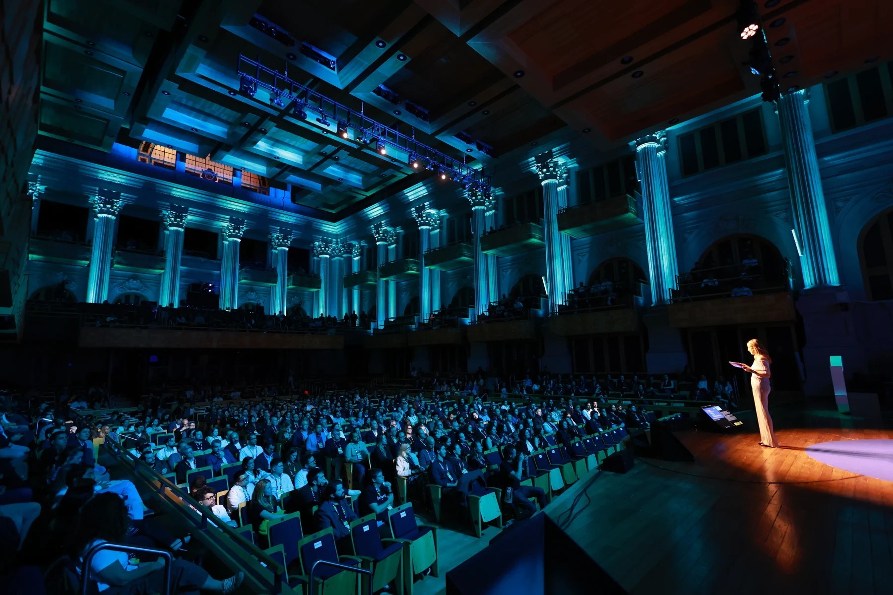View of the audience and stage at Day1 Endeavor in Sala São Paulo, with blue lighting.