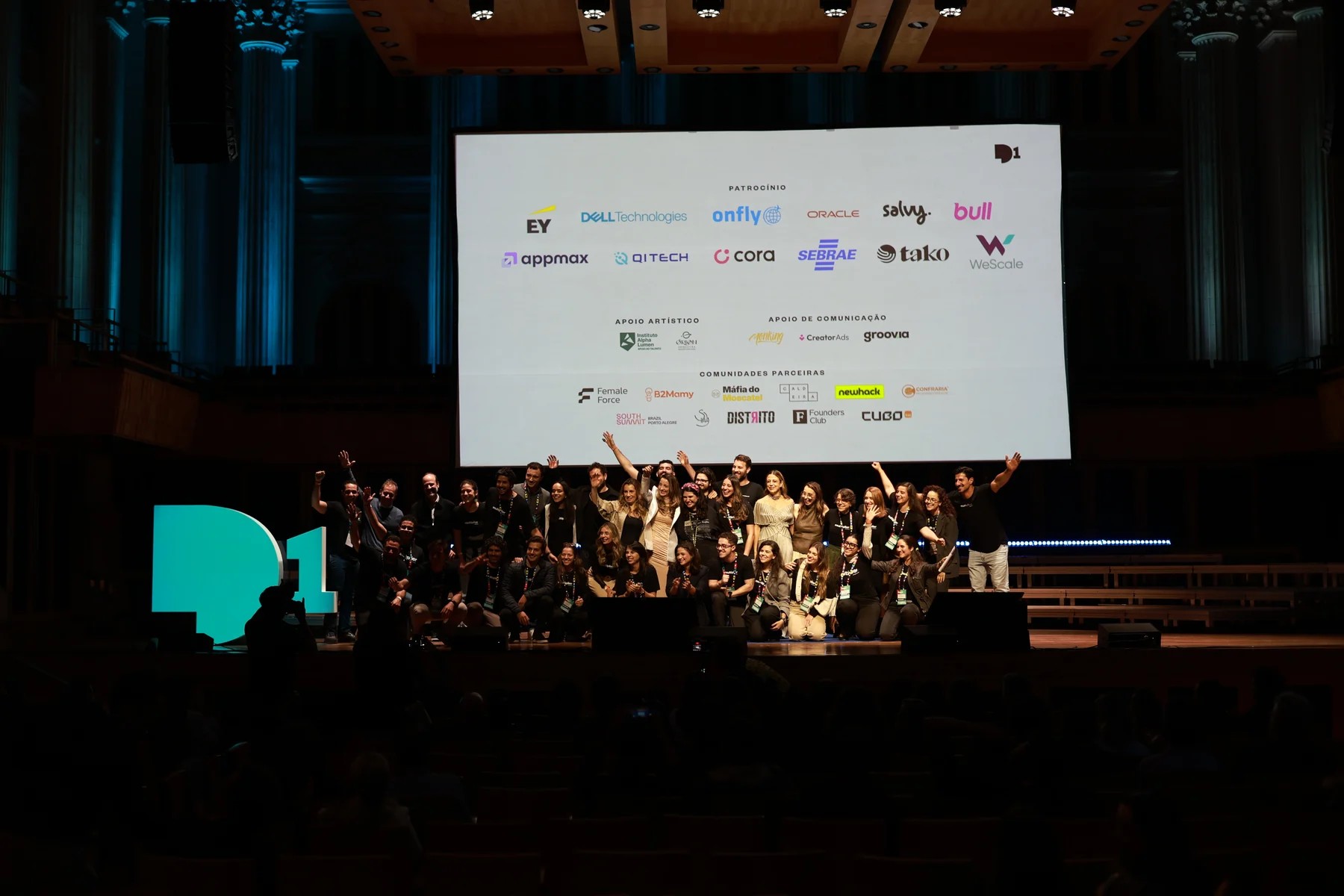 A group on the Day1 Endeavor stage in front of the partner panel, with NewHack among the community partners.